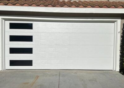 White garage door installation with side window design